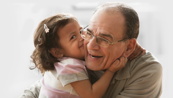 grandfather hugging granddaughter