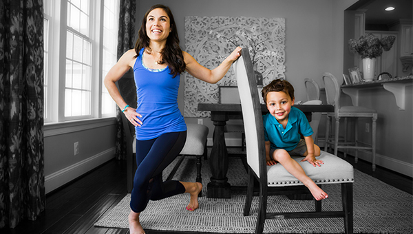 mom exercising while son sits in chair