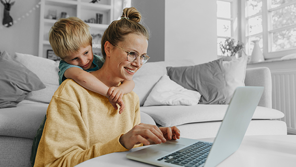 Mother and son look at laptop computer