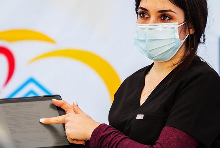 Woman pointing at tablet