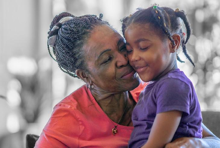 grandmother hugging granddaughter