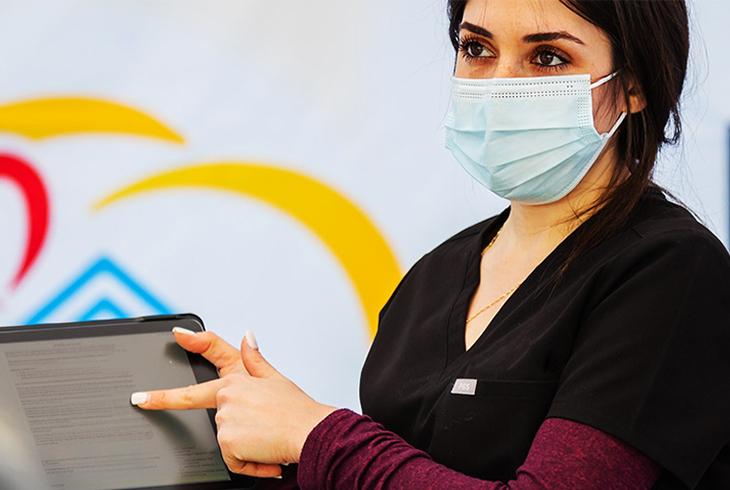 woman pointing at tablet